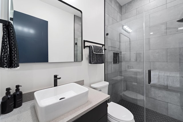 full bathroom with vanity, a stall shower, and toilet