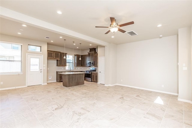 5546 Sallow Bay Ln, Fulshear, TX 77441 - kitchen with visible vents, a kitchen island, appliances with stainless steel finishes, open floor plan, and ceiling fan