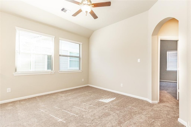 5546 Sallow Bay Ln, Fulshear, TX 77441 - carpeted empty room featuring arched walkways, vaulted ceiling, baseboards, visible vents, and a ceiling fan