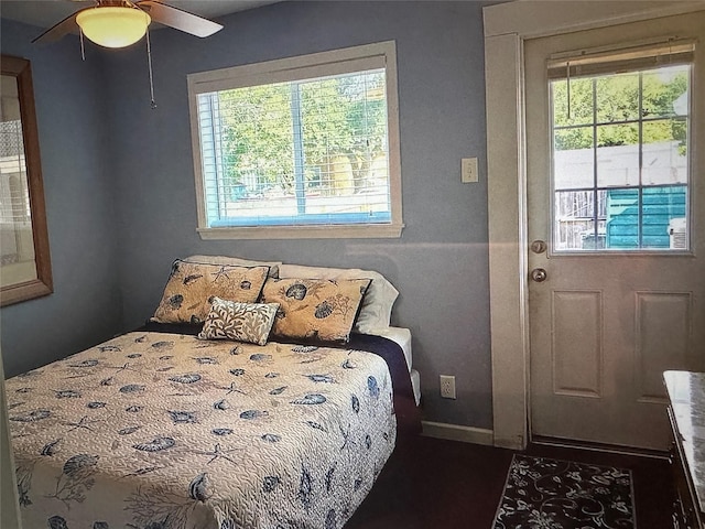 bedroom with ceiling fan and multiple windows