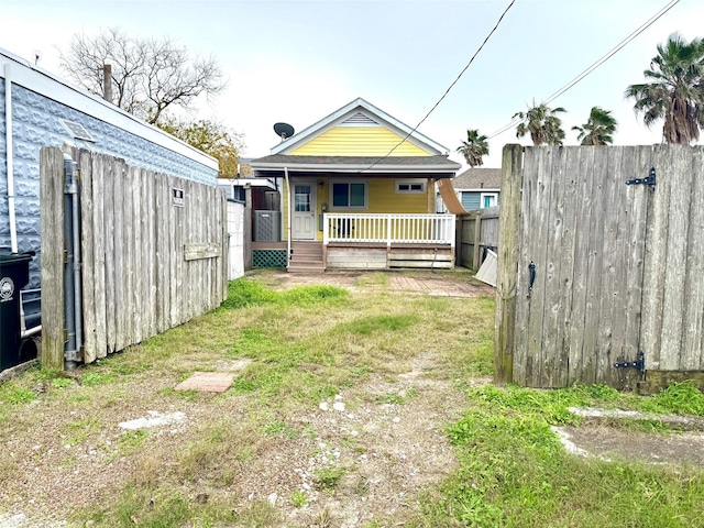 view of yard featuring a porch and fence