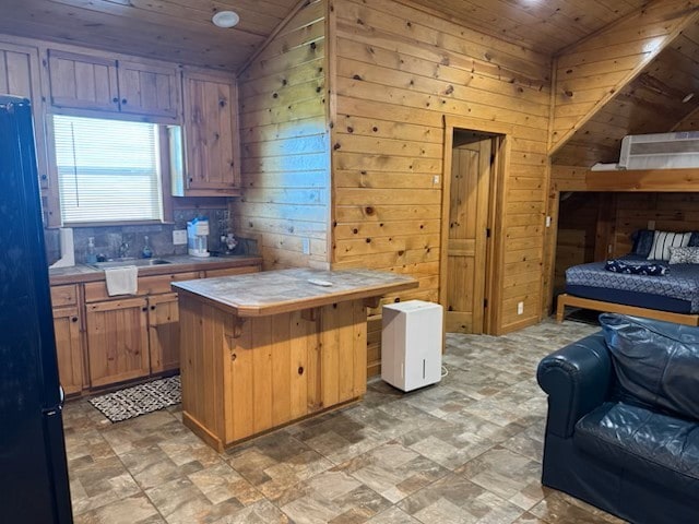 kitchen featuring wooden walls, tile countertops, wood ceiling, and lofted ceiling