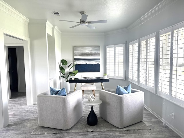 12924 Stewart Rd, Galveston, TX 77554 - living room featuring ceiling fan, baseboards, ornamental molding, and wood finished floors
