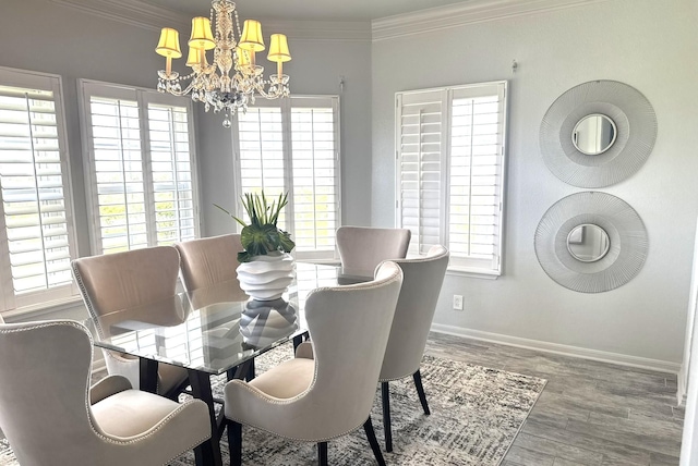 12924 Stewart Rd, Galveston, TX 77554 - dining room featuring a chandelier, wood finished floors, ornamental molding, and baseboards