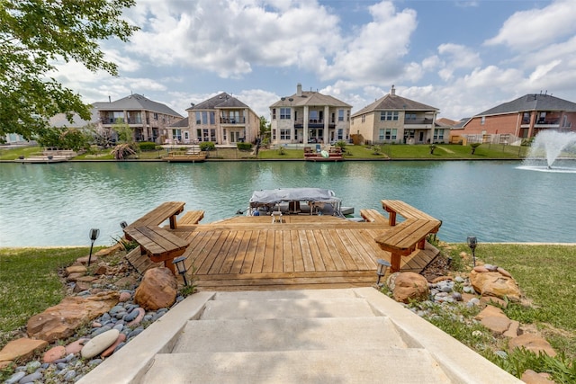 view of dock featuring a water view and a residential view