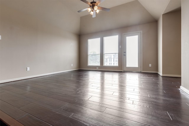 empty room with dark wood-style flooring, ceiling fan, baseboards, and lofted ceiling