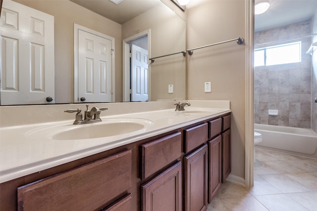 full bathroom with a sink, tile patterned floors, toilet, and double vanity