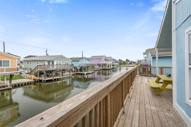 dock area featuring a deck with water view and a residential view