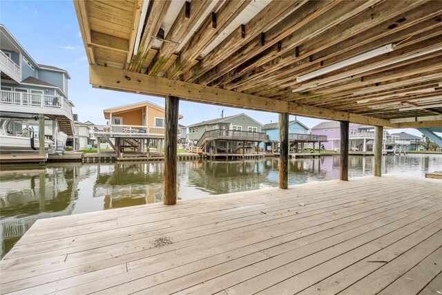 dock area featuring a residential view and a water view