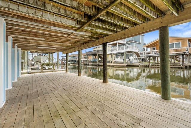 dock area with a water view and a residential view
