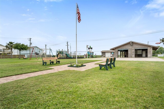 view of home's community featuring a lawn, playground community, and fence