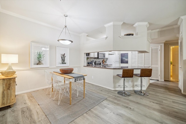 2111 Welch St Unit A219, Houston, TX 77019 - dining area featuring wood finished floors, crown molding, and baseboards
