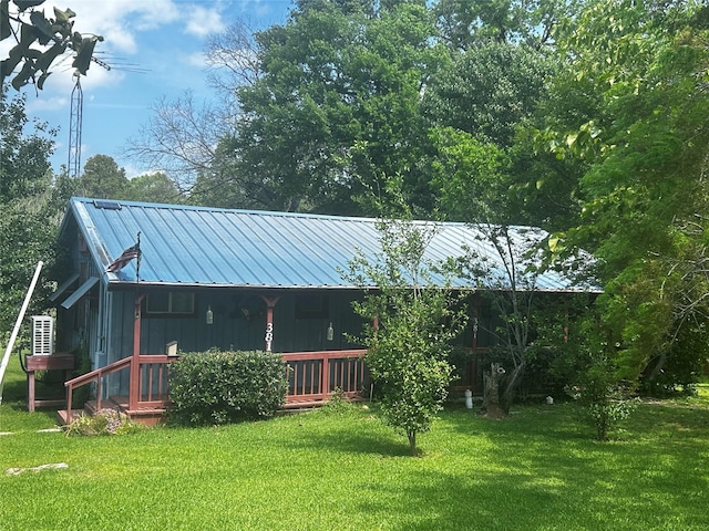 381 Lakeshore Dr, Cleveland, TX 77327 - back of property with a lawn and metal roof