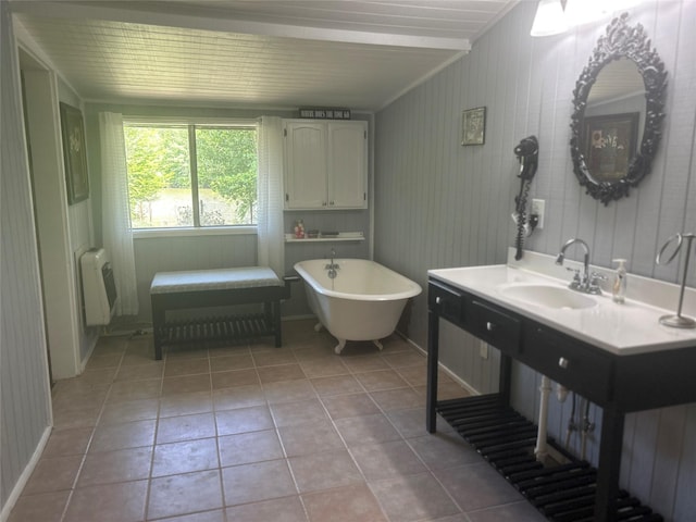 381 Lakeshore Dr, Cleveland, TX 77327 - bathroom featuring radiator, tile patterned floors, a soaking tub, and a sink