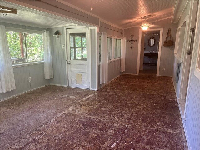 381 Lakeshore Dr, Cleveland, TX 77327 - spare room with baseboards, a ceiling fan, and wood walls