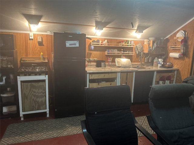 381 Lakeshore Dr, Cleveland, TX 77327 - interior space with wood walls and freestanding refrigerator