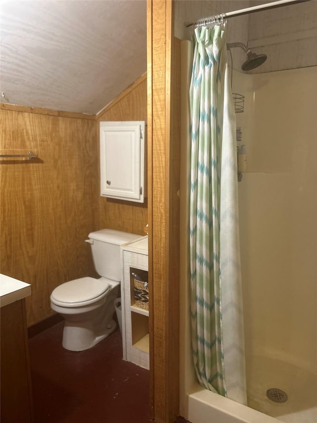 381 Lakeshore Dr, Cleveland, TX 77327 - bathroom featuring a shower stall, lofted ceiling, wooden walls, toilet, and vanity