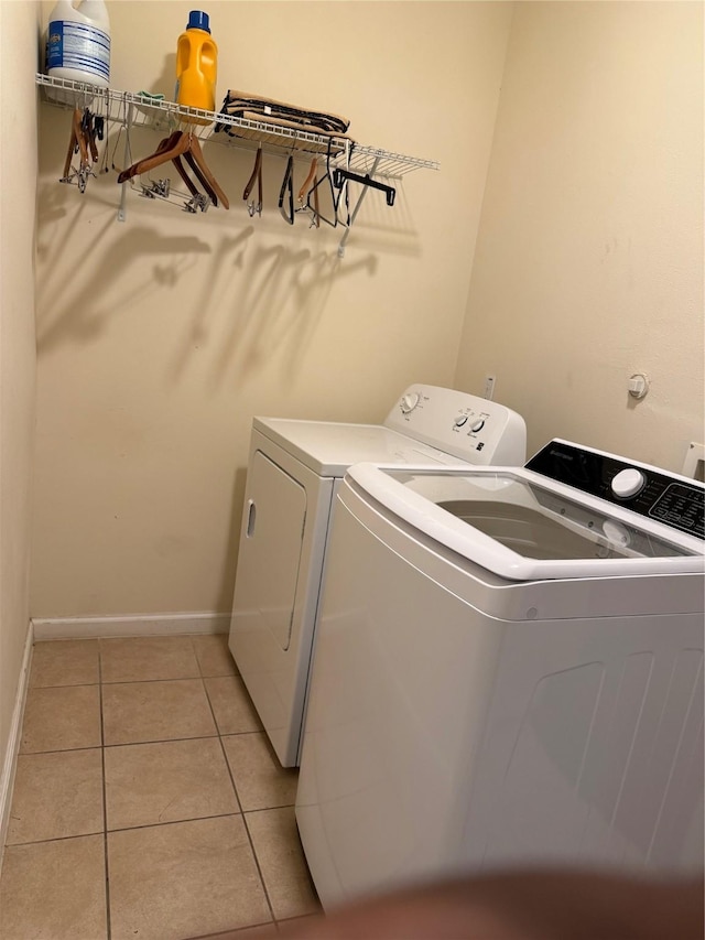 4212 Knoxville St, Houston, TX 77051 - laundry area with baseboards, washer and clothes dryer, laundry area, and light tile patterned floors