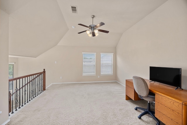 office area featuring lofted ceiling, a ceiling fan, baseboards, and light colored carpet