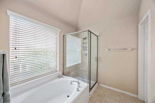 full bathroom featuring tile patterned floors, a garden tub, baseboards, and a stall shower