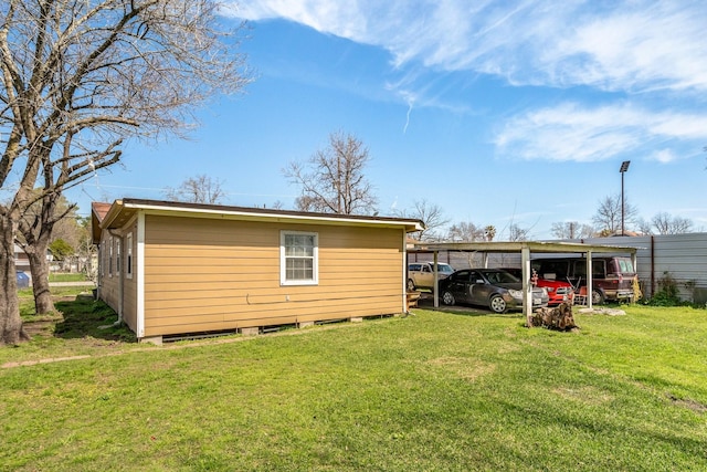 exterior space with a yard and a detached carport