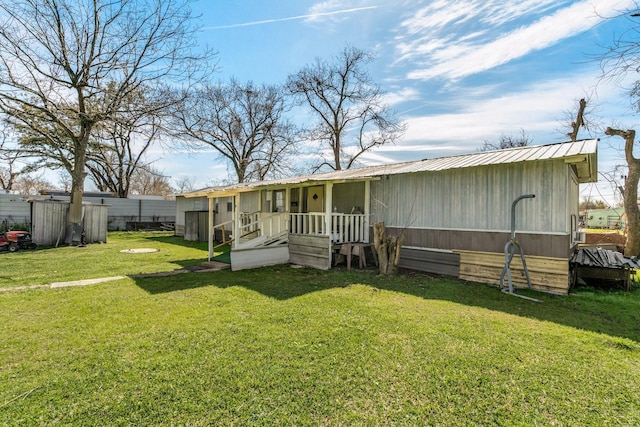 back of property with a lawn