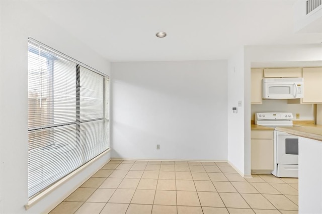 kitchen with recessed lighting, light countertops, visible vents, white appliances, and baseboards