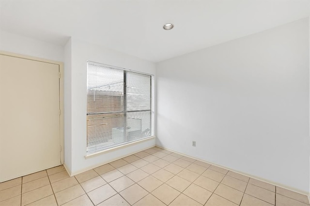 spare room featuring recessed lighting and light tile patterned floors