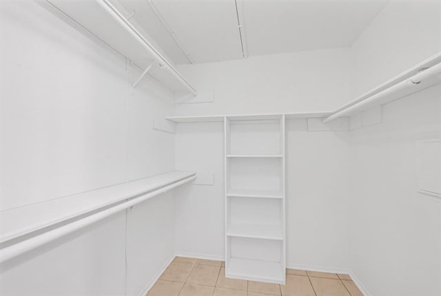 walk in closet featuring light tile patterned flooring