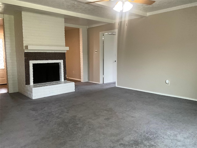 unfurnished living room with a ceiling fan, a brick fireplace, and dark carpet