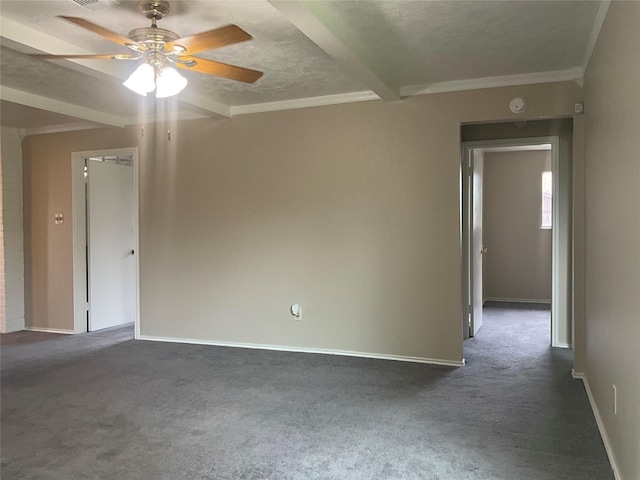 unfurnished room featuring ceiling fan, baseboards, dark colored carpet, and beam ceiling