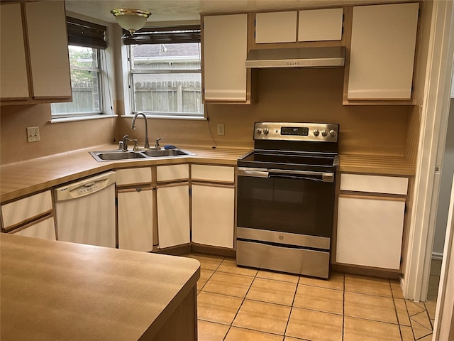 kitchen featuring a sink, stainless steel range with electric stovetop, dishwasher, light countertops, and range hood