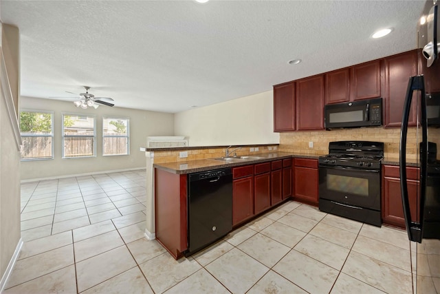 kitchen with dark brown cabinets, a sink, decorative backsplash, black appliances, and a peninsula