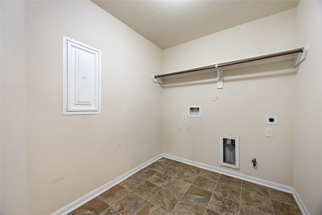 clothes washing area with hookup for a gas dryer, baseboards, electric dryer hookup, and laundry area