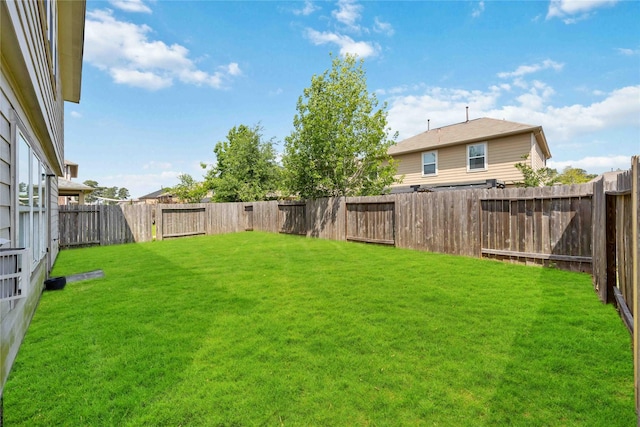 view of yard with a fenced backyard