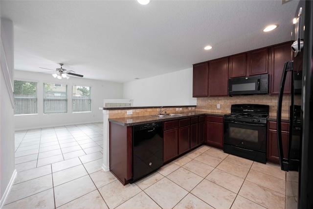 9939 Chimney Swift Ln, Conroe, TX 77385 - kitchen with black appliances, a peninsula, tasteful backsplash, light tile patterned floors, and recessed lighting