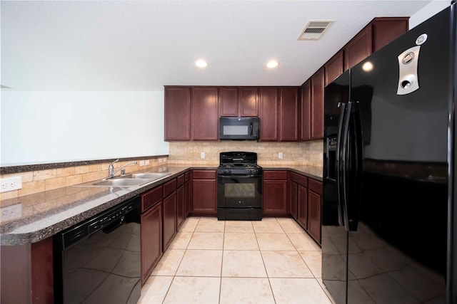 9939 Chimney Swift Ln, Conroe, TX 77385 - kitchen featuring black appliances, backsplash, light tile patterned floors, recessed lighting, and dark countertops