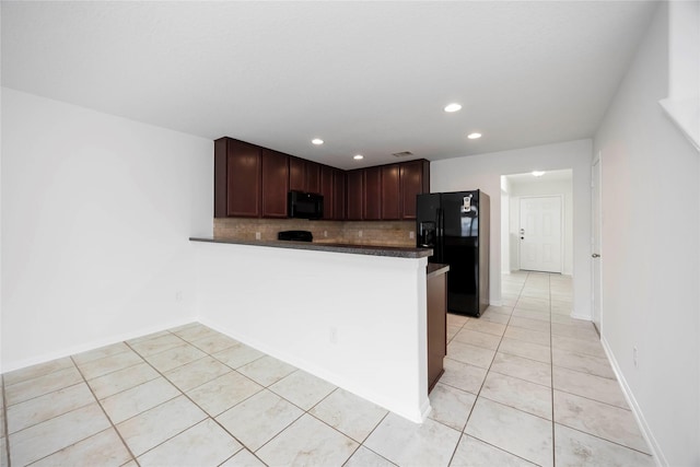 9939 Chimney Swift Ln, Conroe, TX 77385 - kitchen featuring black appliances, dark countertops, tasteful backsplash, light tile patterned flooring, and recessed lighting