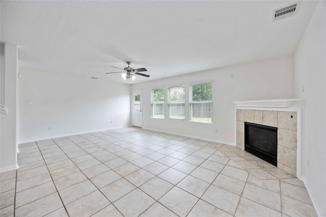 9939 Chimney Swift Ln, Conroe, TX 77385 - unfurnished living room featuring a fireplace, light tile patterned floors, and a ceiling fan