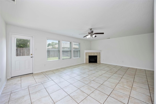9939 Chimney Swift Ln, Conroe, TX 77385 - unfurnished living room featuring a ceiling fan, light tile patterned floors, and a tiled fireplace