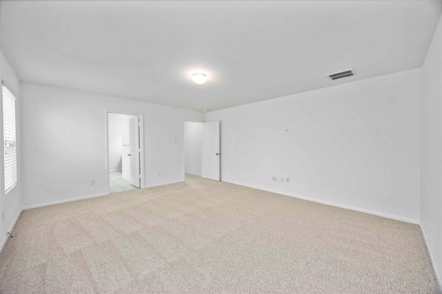 9939 Chimney Swift Ln, Conroe, TX 77385 - unfurnished bedroom featuring light carpet and ensuite bathroom