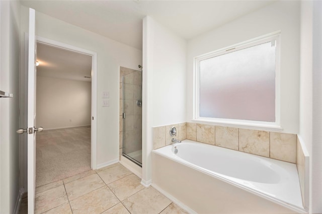9939 Chimney Swift Ln, Conroe, TX 77385 - full bathroom with a bath, a shower stall, and tile patterned floors