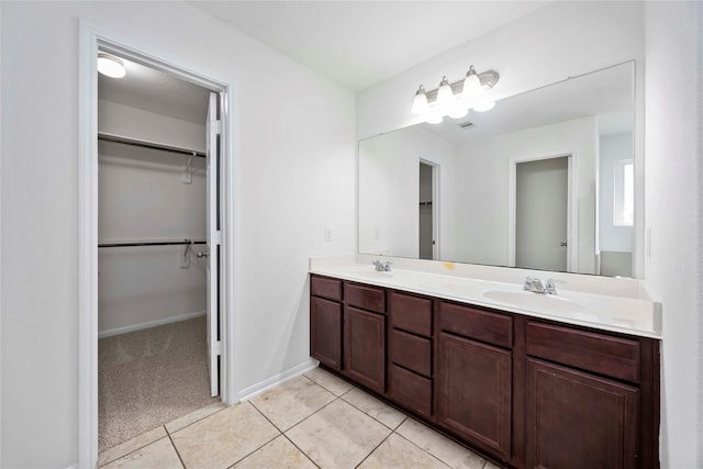 9939 Chimney Swift Ln, Conroe, TX 77385 - full bath featuring double vanity, tile patterned flooring, and a spacious closet