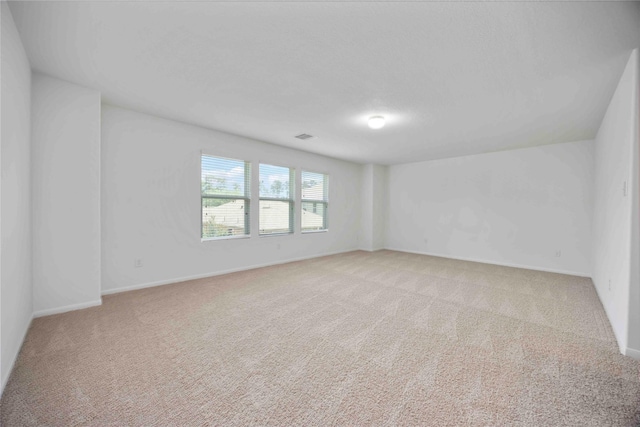 9939 Chimney Swift Ln, Conroe, TX 77385 - spare room featuring light colored carpet