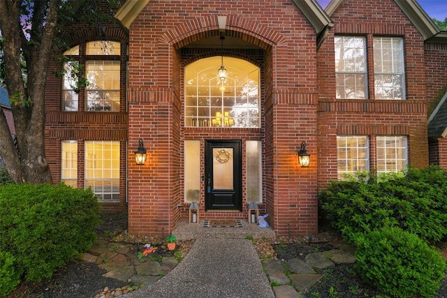 view of exterior entry with brick siding