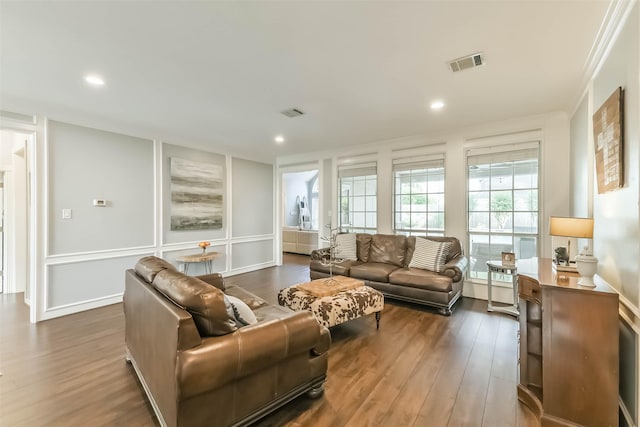 living room with recessed lighting, visible vents, and dark wood-style floors