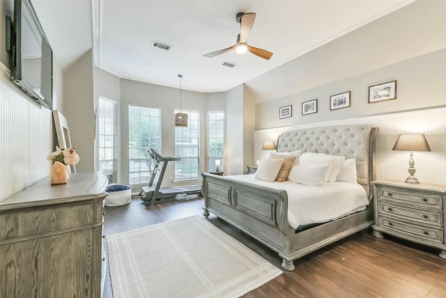 bedroom with dark wood-type flooring, visible vents, and ceiling fan
