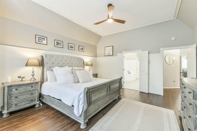 bedroom with vaulted ceiling, ensuite bathroom, a ceiling fan, and dark wood-style flooring