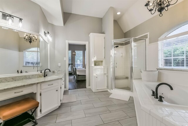 bathroom featuring a shower stall, a chandelier, and a healthy amount of sunlight
