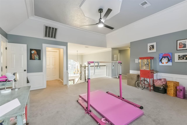 exercise room with ornamental molding, a ceiling fan, visible vents, and carpet